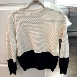 Size smaller black/white sweater in perfect condition